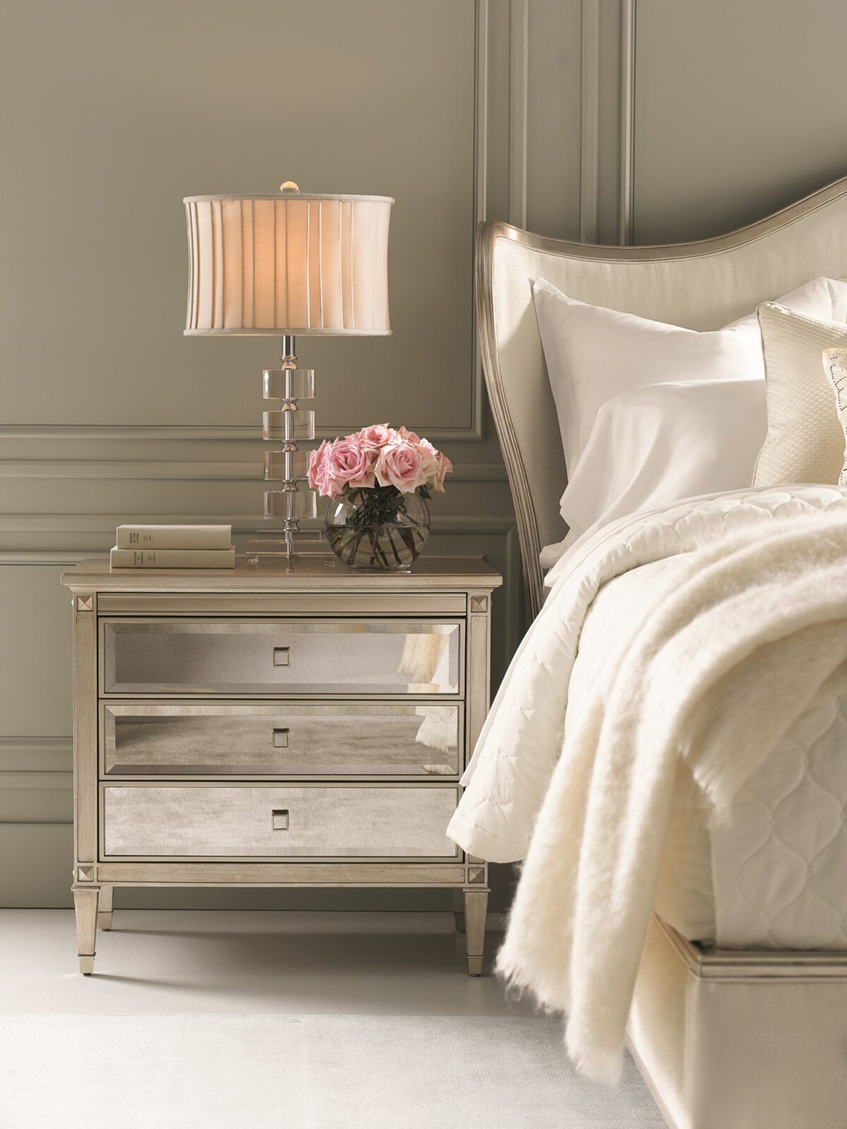 A Classic Beauty by Caracole — a 32″ wide Italian-inspired nightstand with three soft-close drawers featuring beveled antique-mirror fronts framed in Auric silver leaf finish, square mirrored-inset pulls, carved tapered feet with metal ferrules, and a sparkling gold-painted interior shelf.