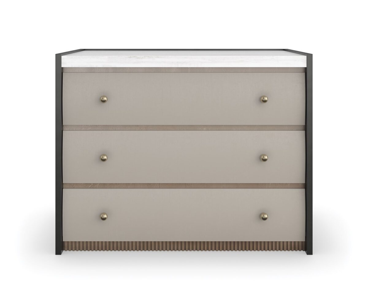 Avignon Bronze Nightstand by Caracole — a 34″‑wide classic nightstand with three soft‑close drawers featuring tactile Rockport Burnished Adobe fronts, set within Craftsman Bronze‑painted end panels; topped with striated white Guangxi stone, trimmed with antique‑bronze‑leaf dentil molding at the base, brushed‑gold ball knobs, and painted Almond Milk interiors.