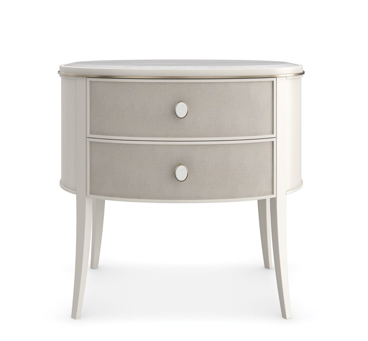 Bruges Nightstand by Caracole — a 28″‑wide oval bedside chest featuring a beveled Guangxi marble top, two vinyl‑wrapped drawers with linen-like texture and brushed‑gold metal bead inlay, set in an Almond Milk painted acacia wood case with jewelry-style round pulls, soft‑close undermount guides, and Almond Milk–painted interiors.