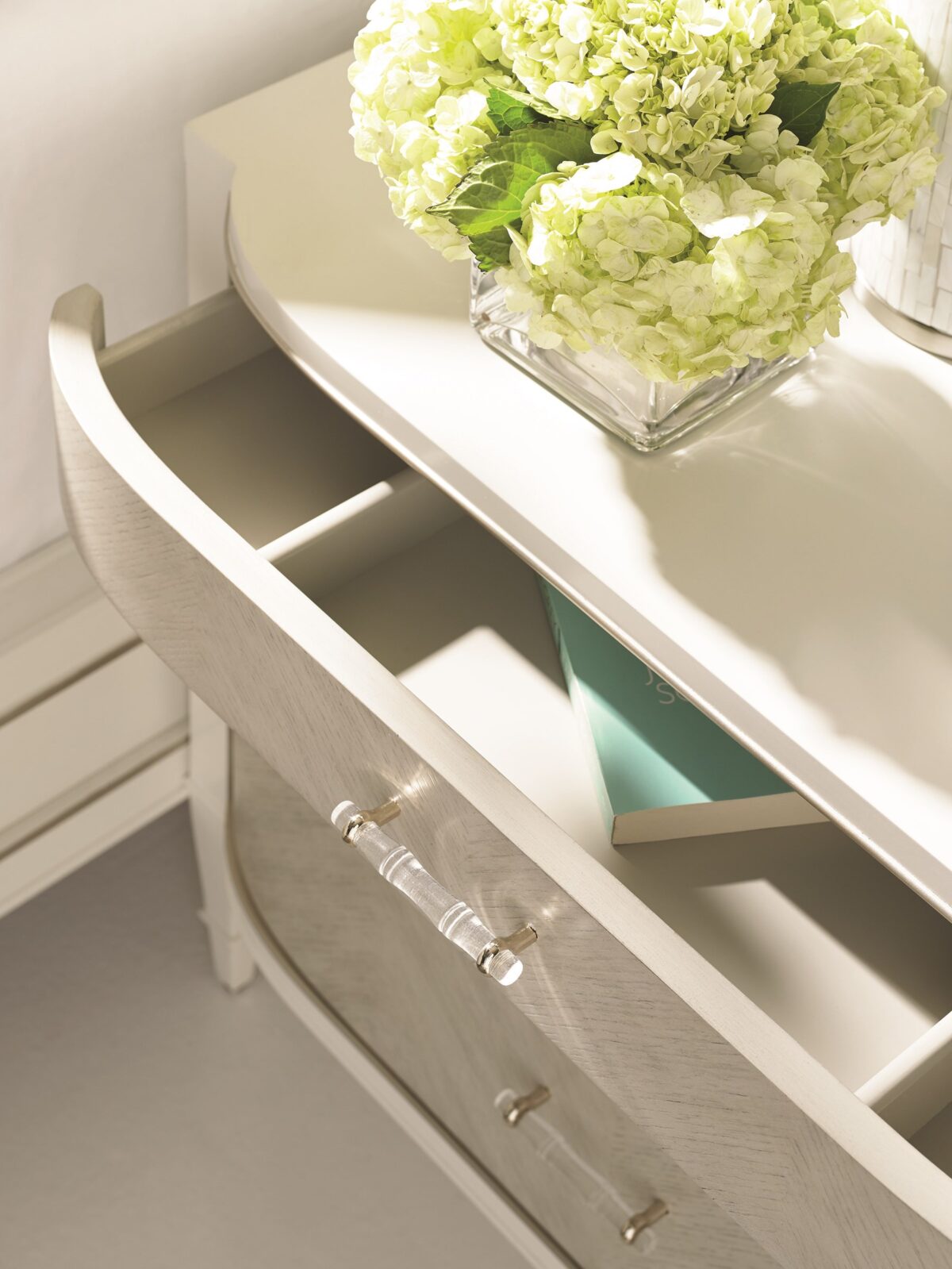 Modern chest of drawers with a unique wrapped exterior and contrasting metallic accents, DOUBLE WRAP by Caracole.