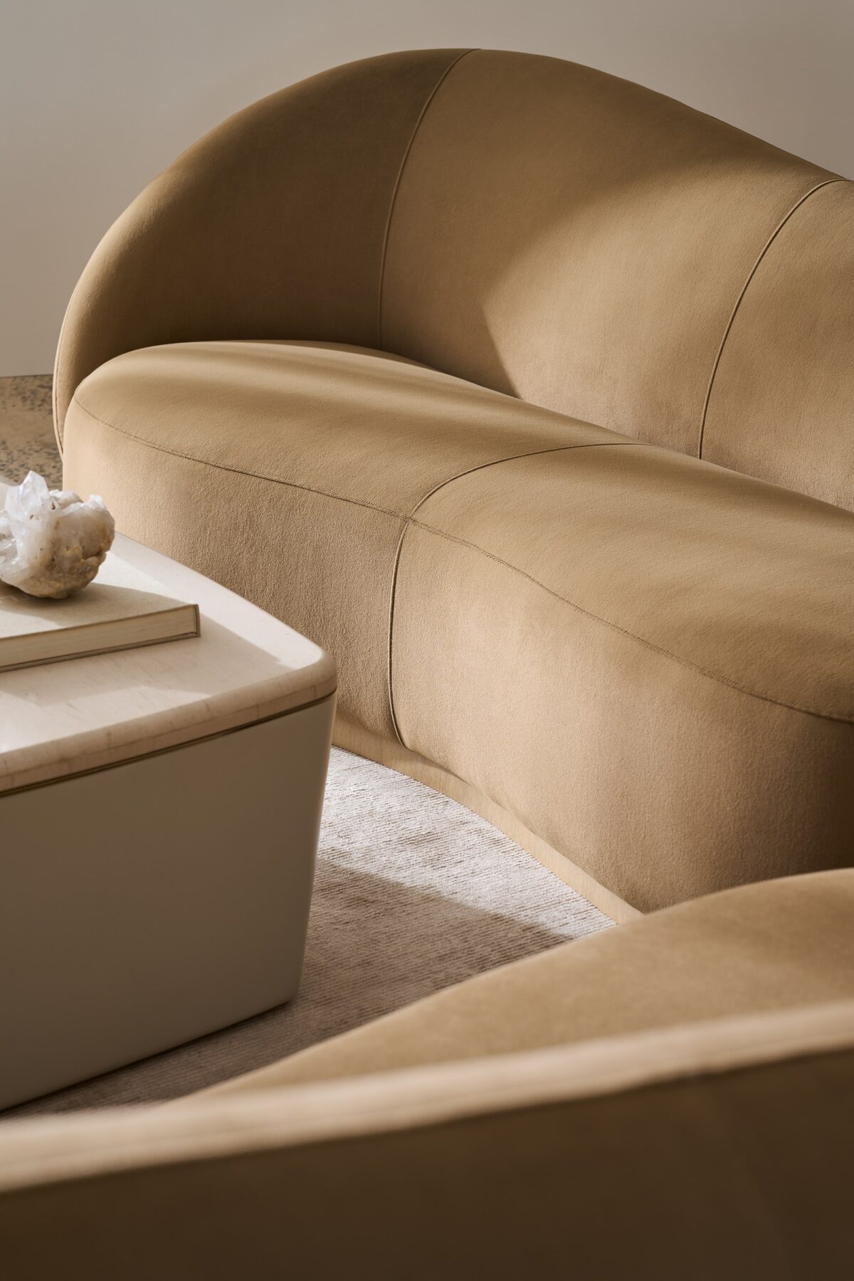 Caracole Kalahari LAF Sofa featuring a sculptural, serpentine open seat design, fully upholstered in camel-colored angora-like velvet, with a base finished in Sparkling Argent.