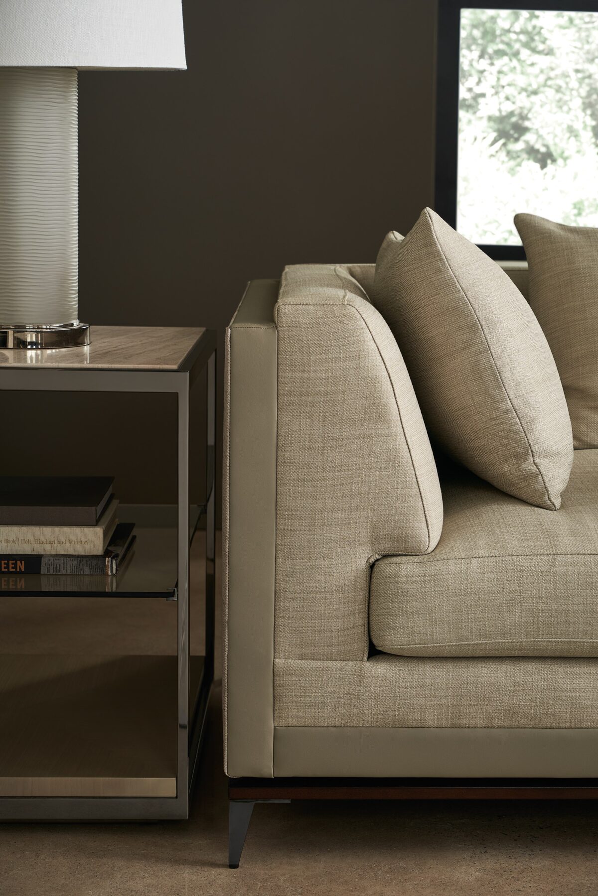 Caracole Archipelago LAF Loveseat featuring neutral twill upholstery with faux leather accents, exposed Bourbon Glaze wood base