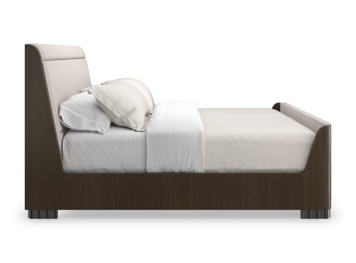 Caracole Slow Wave King Bed featuring a canted upholstered headboard and clean-lined footboard in faux slub silk, complemented by an Otter-finished footboard and side rails, and fluted Dark Chocolate legs.