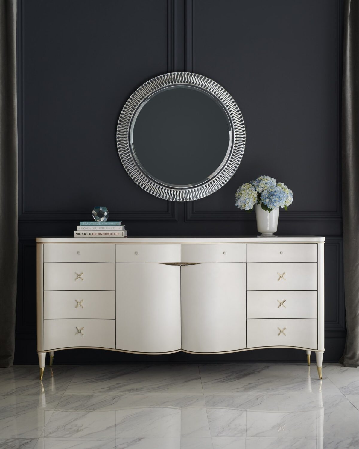 Caracole BELLE OF THE BALL dining table, featuring a spectacular, sculpted base of intertwined forms, often in a metallic or high-gloss finish.