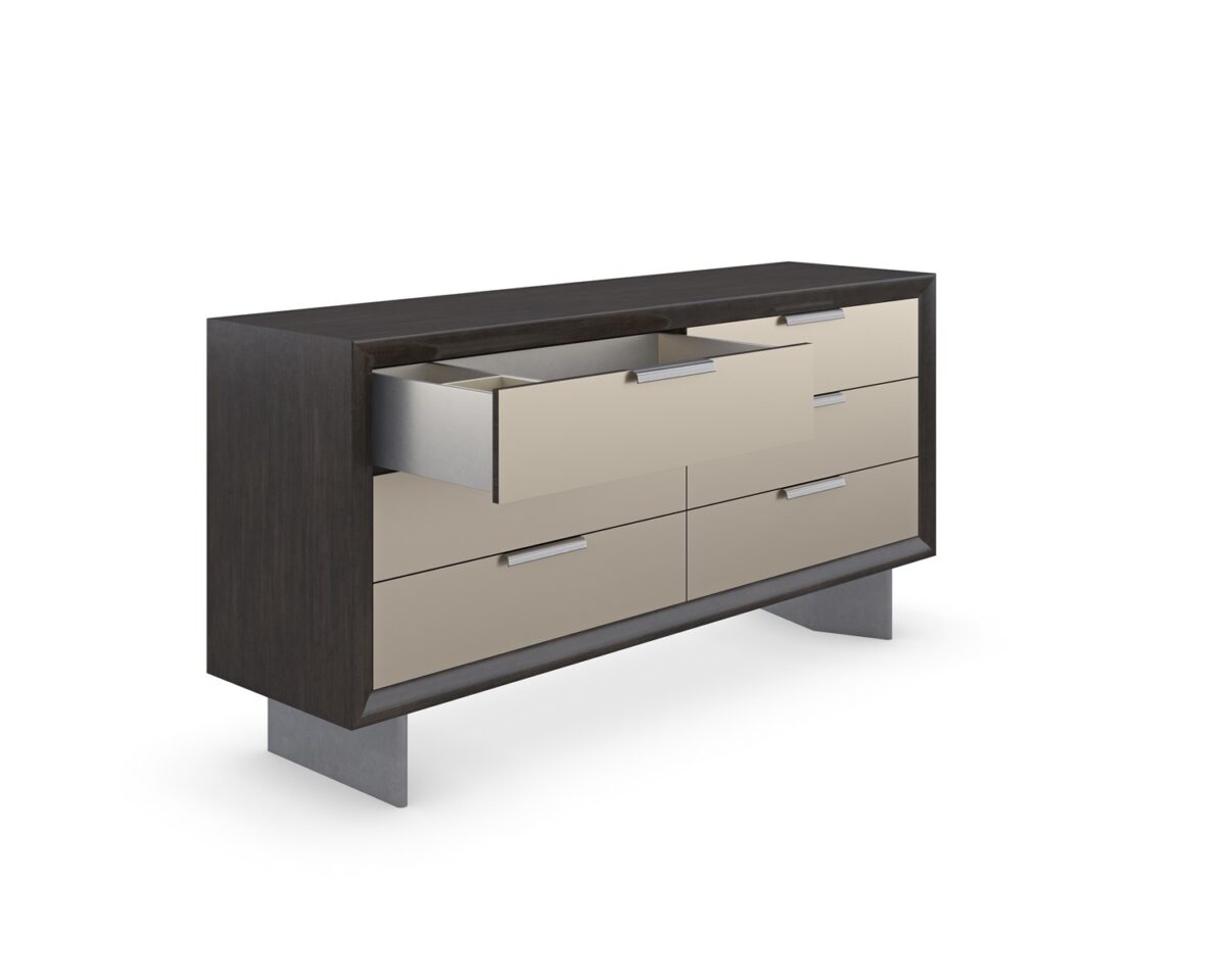 Fashion Dresser by Caracole — a curving six-drawer dresser in lustrous gold-leaf finish, topped with a mirrored bronze surface and slender tapered legs; each drawer features jewelry-like ring pulls and undermount soft-close operation.
