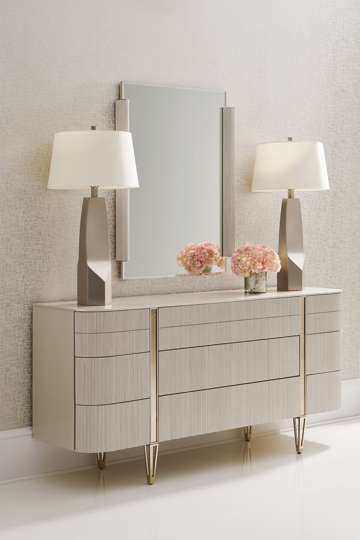 Love at First Sight Dresser by Caracole — a 74″‑wide curved‑front dresser in Matte Pearl finish with nine touch‑latch, reeded drawer fronts, soft‑close undermount guides, and Whisper‑of‑Gold metal legs and band accents.
