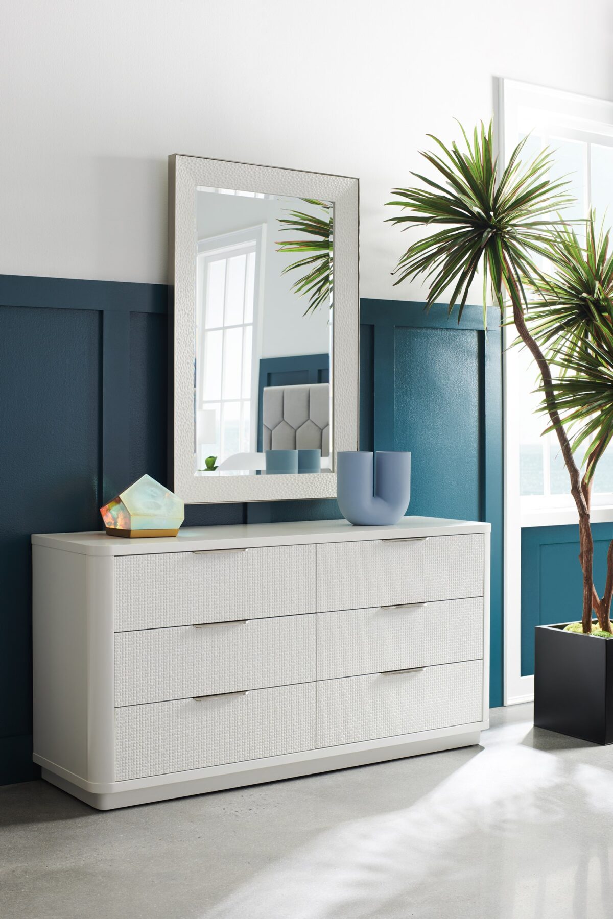 Loving Touch Dresser by Caracole — a 64″‑wide six‑drawer dresser in Cloud White finish, with gently rounded edges, carved drawer fronts featuring a woven mini‑tile motif, clean finger‑cup pulls, and undermount soft‑close guides.