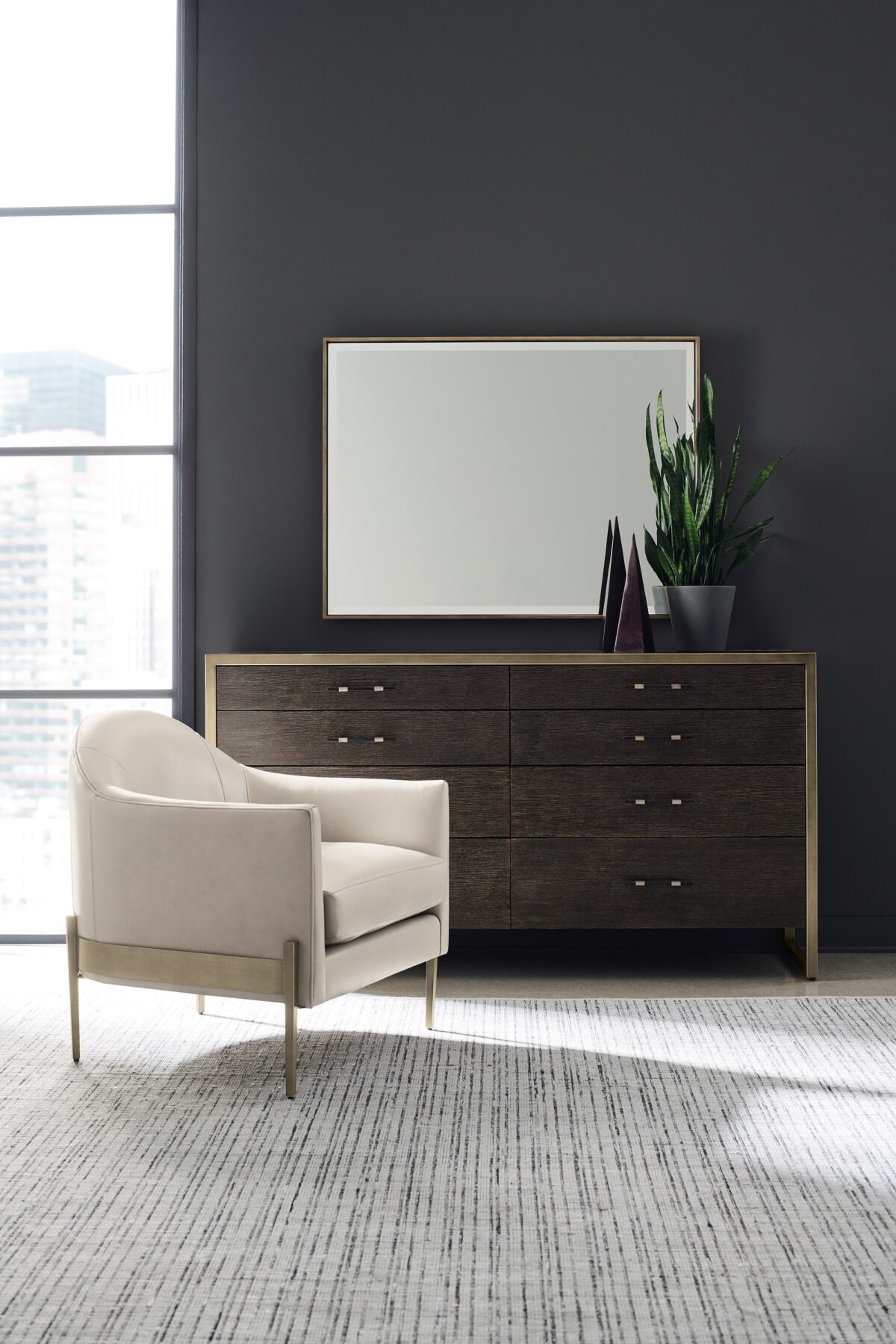 ReMix Double Dresser by Caracole — a 66″‑wide double dresser with eight soft‑close drawers; case and interior in black‑stained ash, drawer fronts in cerused oak, accented with a slim bronze‑gold metal frame and matching bronze‑painted trim, including a top‑left drawer with removable dividers.
