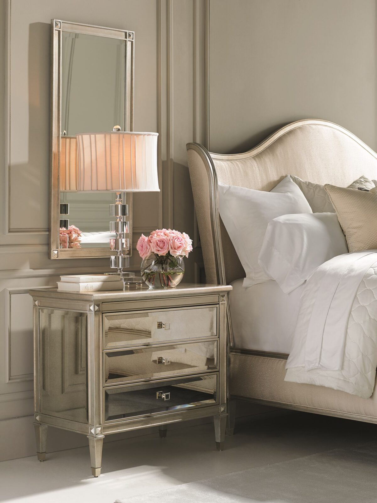 A Classic Beauty by Caracole — a 32″ wide Italian-inspired nightstand with three soft-close drawers featuring beveled antique-mirror fronts framed in Auric silver leaf finish, square mirrored-inset pulls, carved tapered feet with metal ferrules, and a sparkling gold-painted interior shelf.
