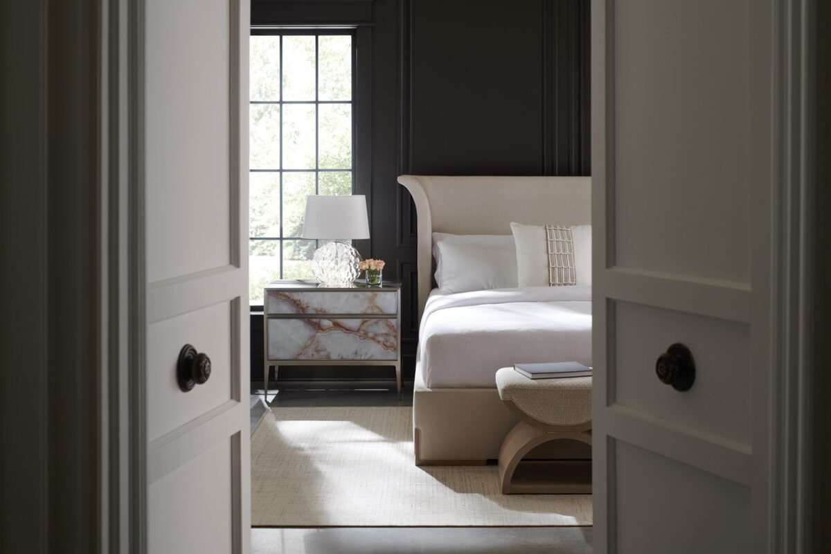 A Real Gem nightstand by Caracole — a 34″‑wide brushed‑nickel metal‐framed chest with two touch‑latch glass drawers painted in agate pattern, slim tapered legs, and a luminous pearl‑painted interior.
