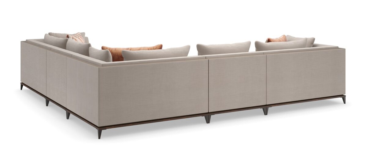 Caracole Archipelago Armless Chair featuring neutral twill upholstery with faux leather accents, exposed Bourbon Glaze wood base, and Deep Bronze metal legs, complemented by a reversible saffron velvet and embroidered geometric pillow.