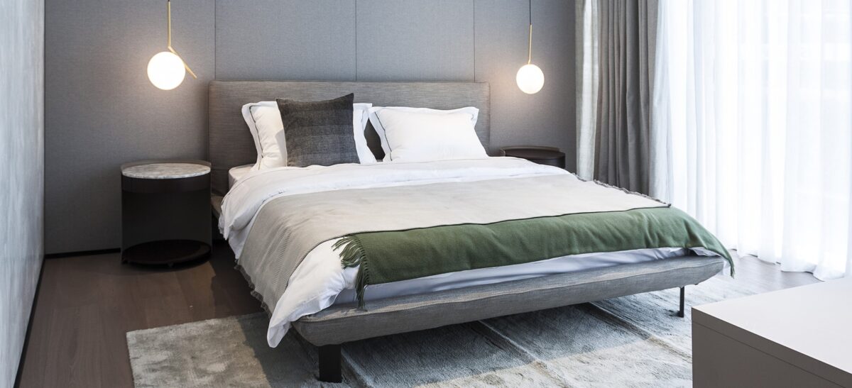 Modern platform bed with slim frame and padded headboard by Camerich.
