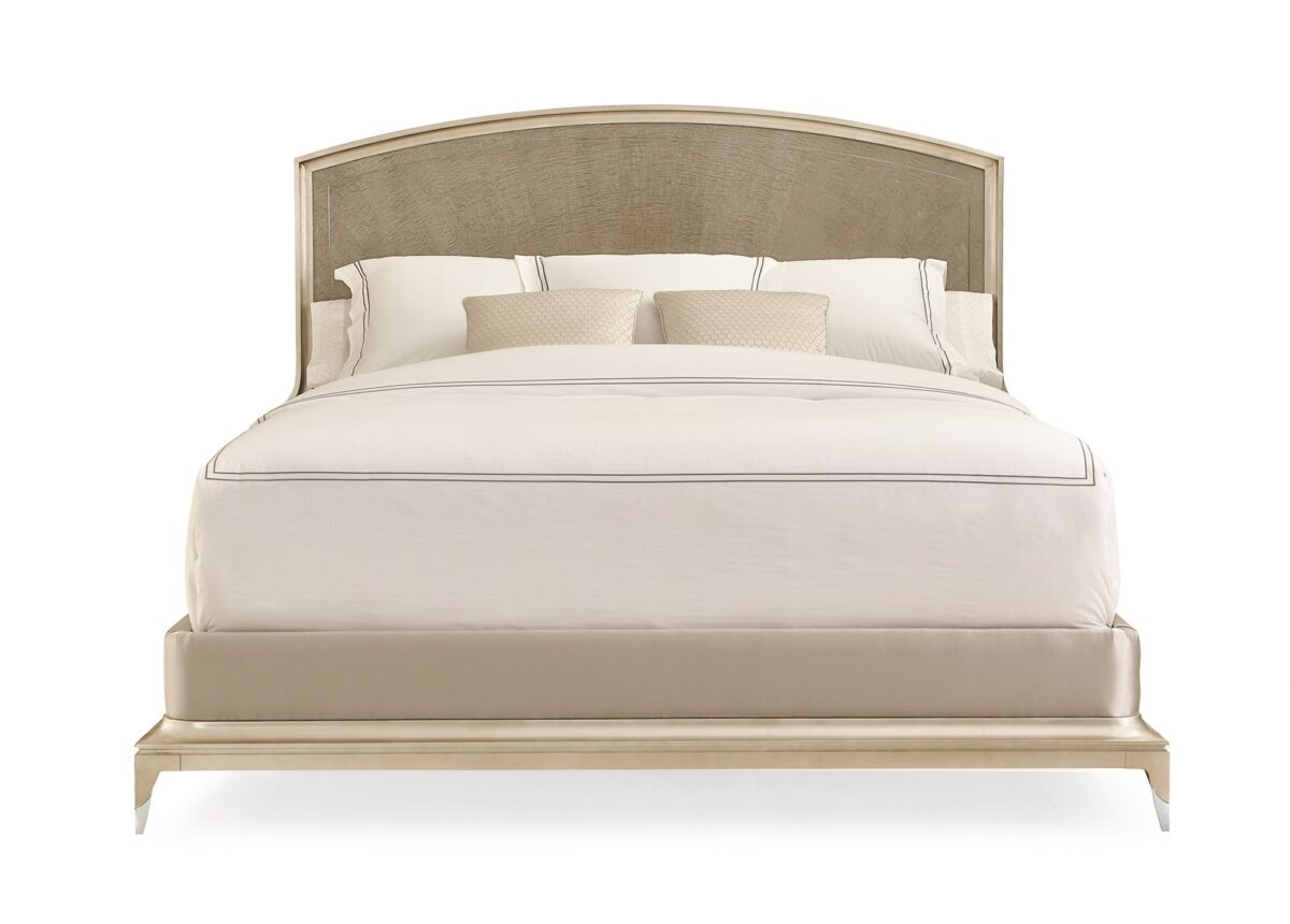 Caracole Rise To The Occasion King Bed featuring a gracefully curved headboard outlined with a metal inlay, crafted from Silver Curly Maple veneers in a Soft Silver Leaf finish, complemented by a Moonlit Sand frame and Lightly Brushed Chrome metal ferrules on the legs.