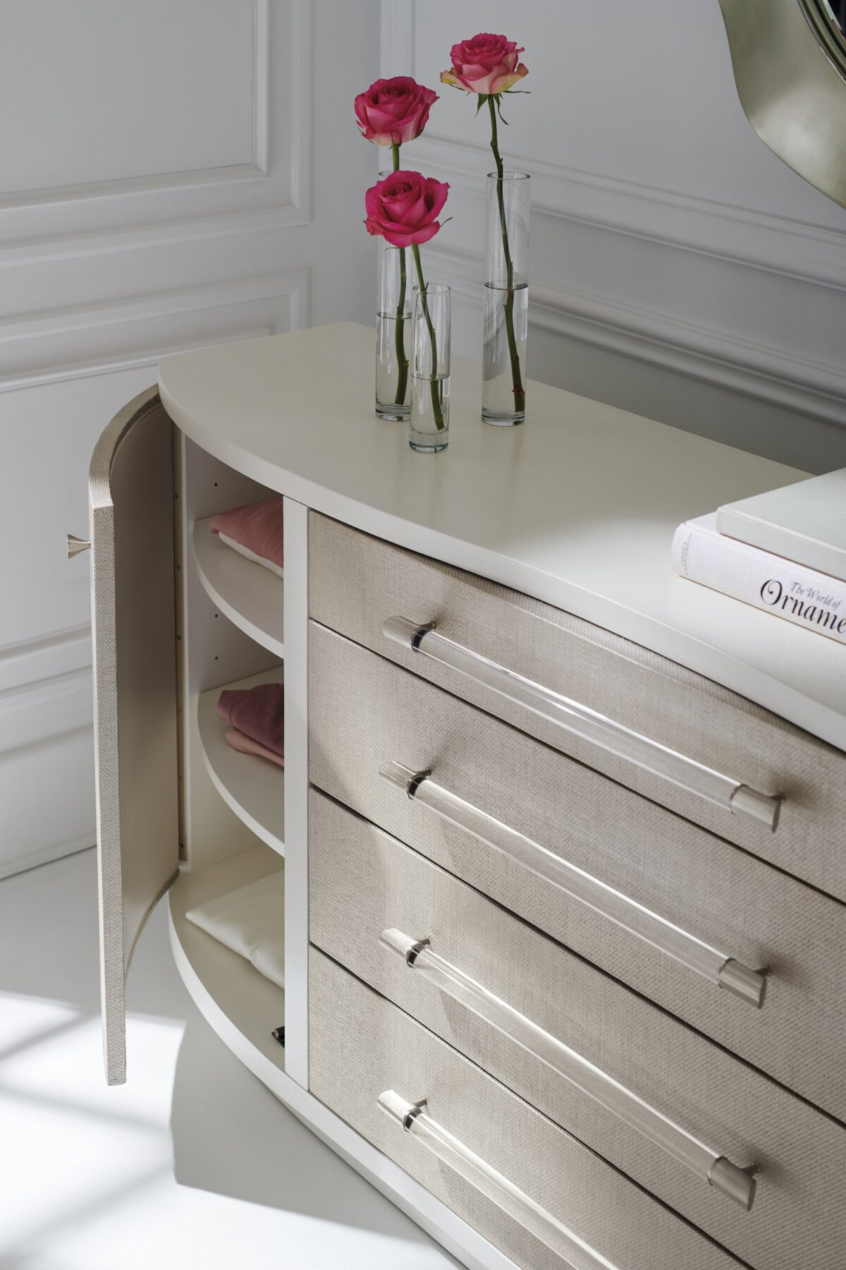 Side profile of the dresser highlighting its gently curved ends, smooth ash veneer finish, and recessed base for a light visual footprint.
