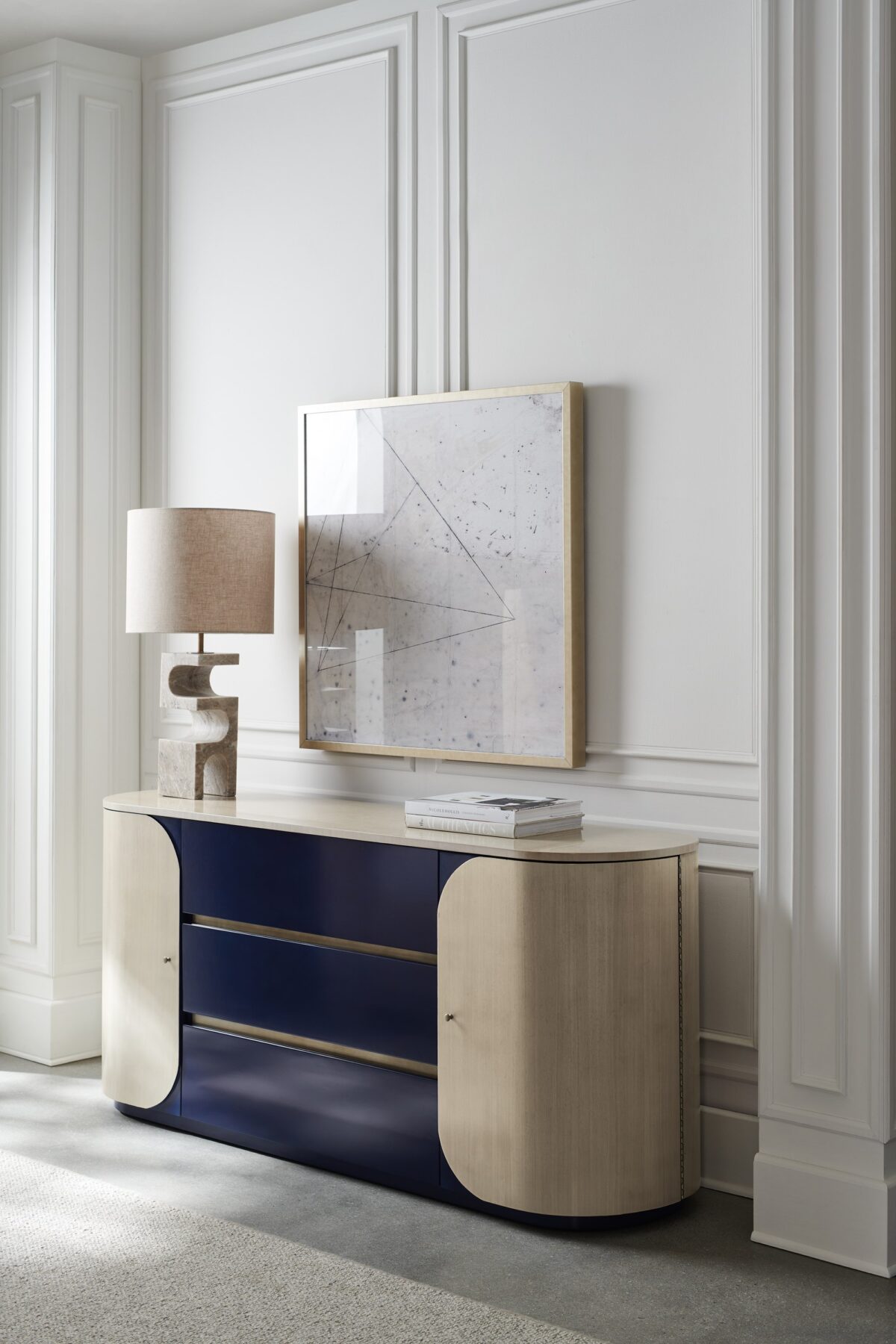 Da Vita Dresser by Caracole with three center drawers in Prussian Blue and curved side doors in Thunder finish, featuring a soft oval silhouette and sleek modern design.
