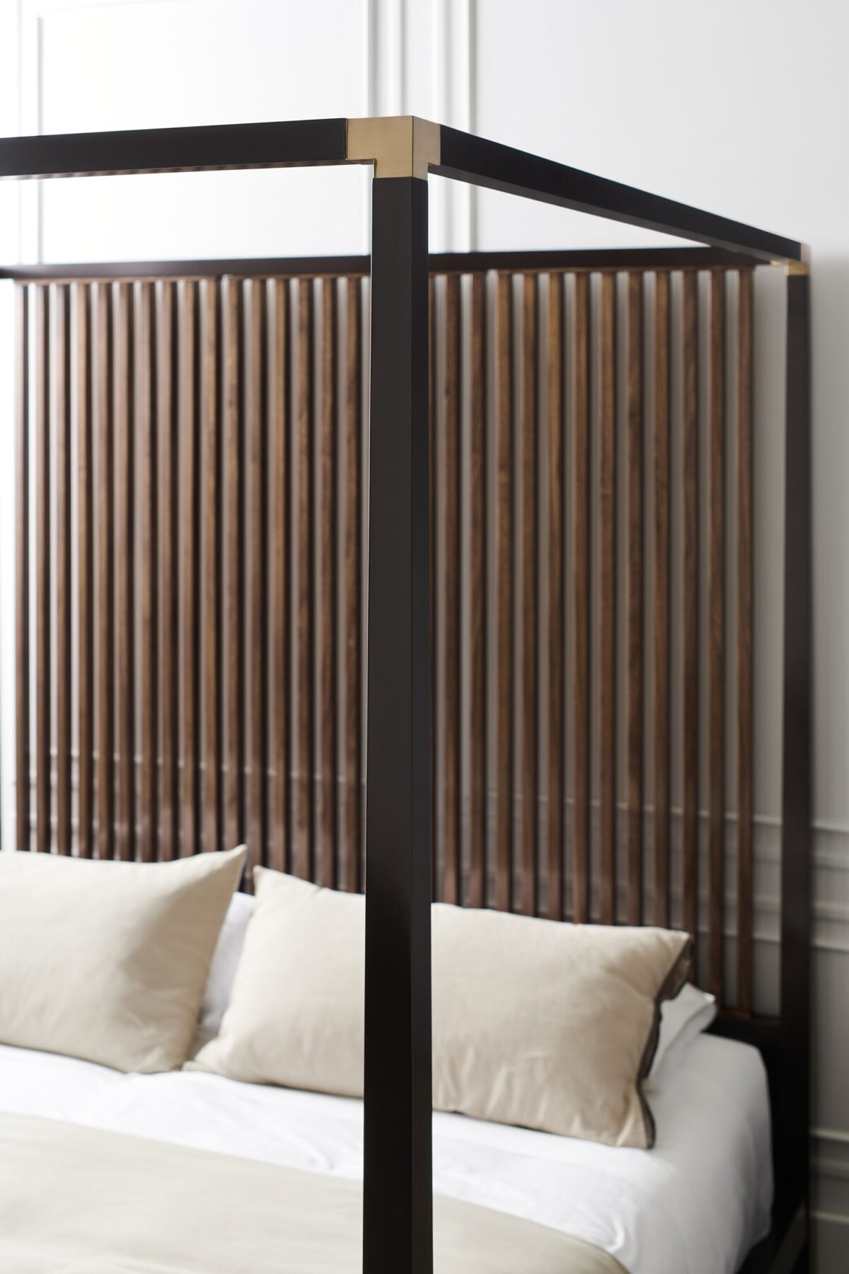 Caracole Pinstripe King Bed featuring a canopy frame in Dark Chocolate finish, complemented by vertical Rich Walnut slats on the headboard, and accented with Champagne Gold metal brackets, creating a modern and elevated look.