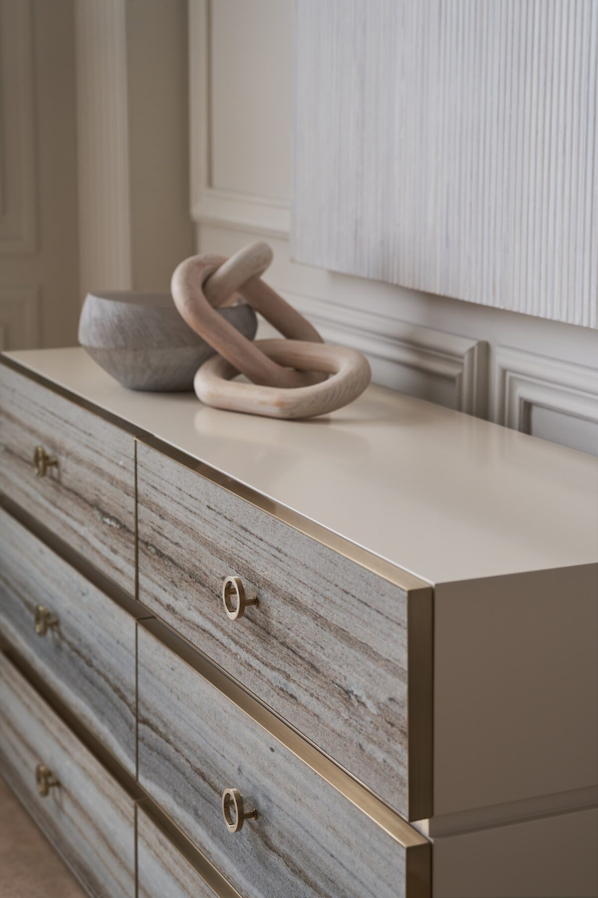 Modern dresser with a textured, layered facade and a sleek, low-profile design, BEDROCK Dresser by Caracole.