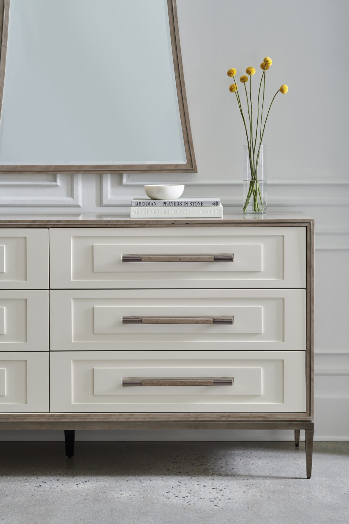 Impressive Dresser by Caracole — a 72″‑wide transitional dresser in Mountain Smoke–finished silver Curupixa veneer, with six stepped Pearly White drawer fronts trimmed in deep bronze metal, featuring jewelry‑style ceramic‑inlay hardware, soft‑close undermount guides, and a coordinating deep bronze metal base.