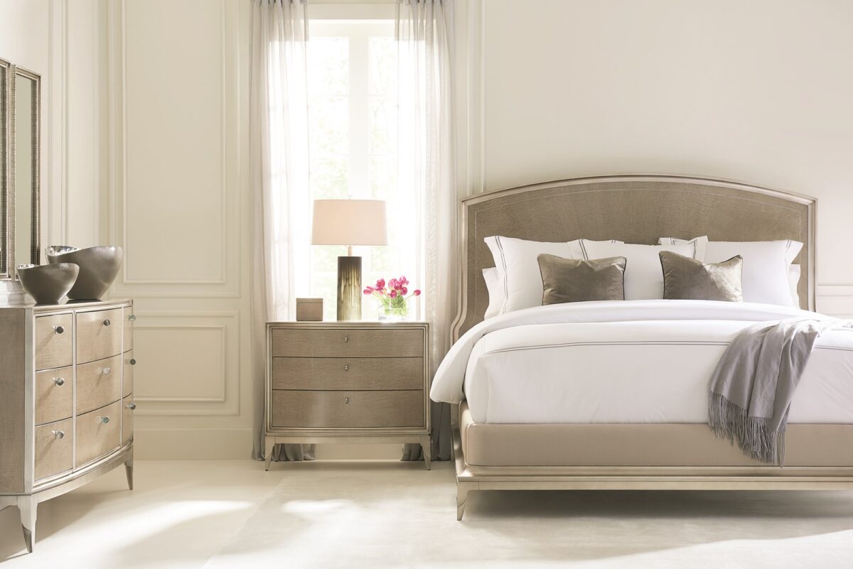 Made To Shine Dresser by Caracole — a 72″ wide nine-drawer dresser in Moonlit Sand–finished curly maple, accented with Soft Silver Leaf trim on the frame and base, topped by lightly brushed chrome metal ferrules on tapered legs, featuring antique silver knobs with black mother-of-pearl centers and soft-close undermount drawer guides.