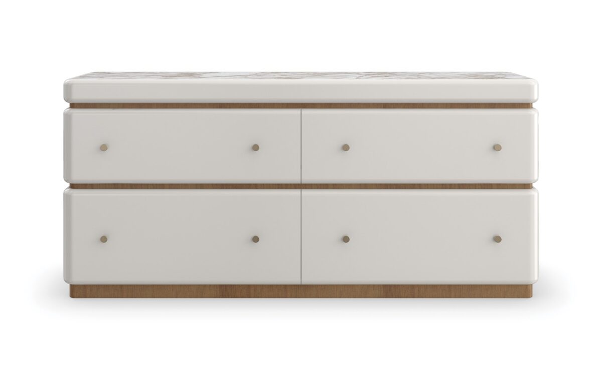 Milos Dresser by Caracole — a 65″‑wide modern dresser in Almond Milk finish with gently rounded stacked silhouette, featuring four soft‑close drawers trimmed in Toasted Pecan, topped with Calacatta Oro marble, and equipped with a removable felt‑lined tray in the top drawer.
