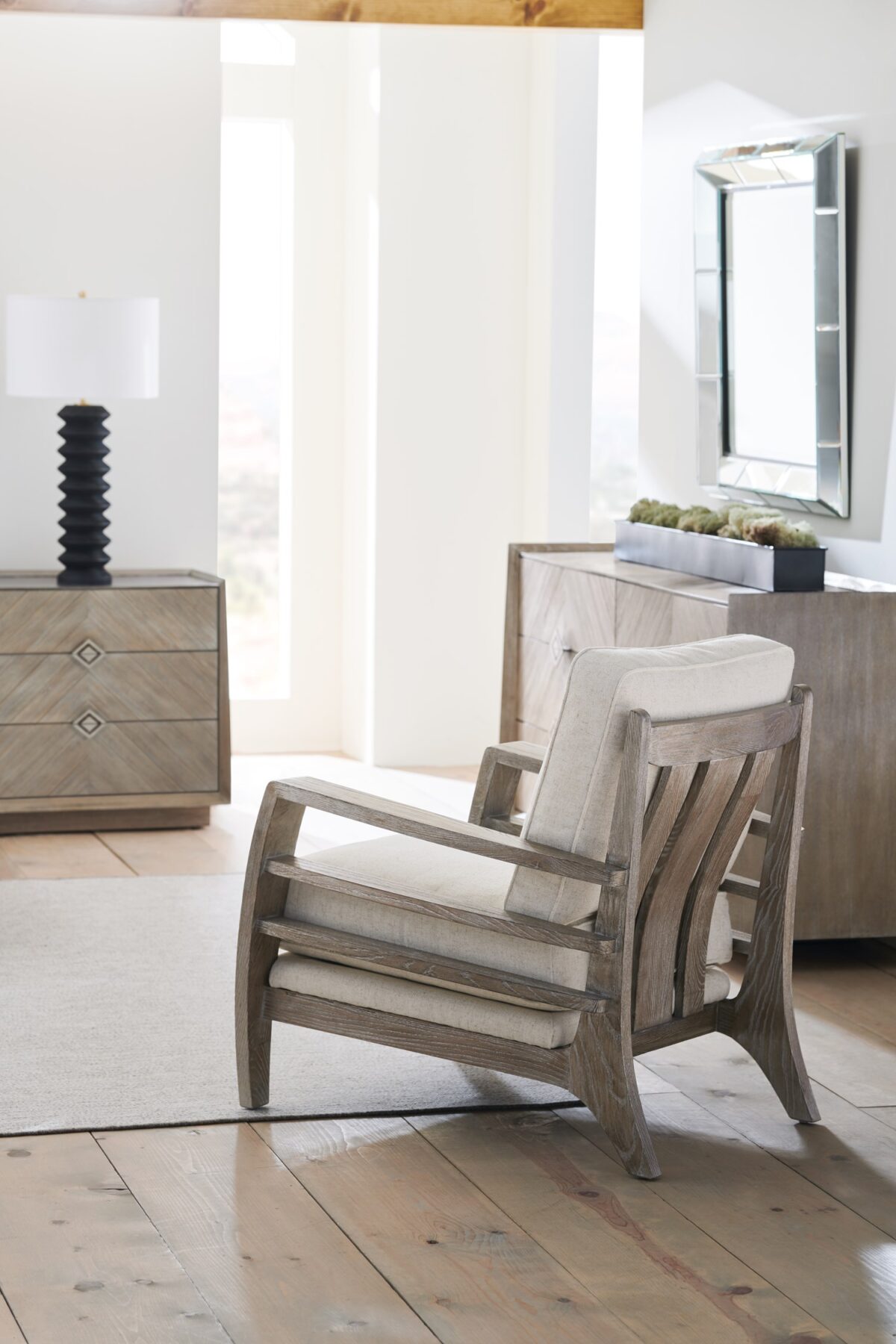 Naturally Dresser by Caracole — a 74″‑wide six‑drawer dresser in Ash Driftwood finish with chevron‑patterned wood‑veneer fronts, accented by a slender Sundance Gold metal bead edging and recessed drawer pulls, all sitting on low block feet.