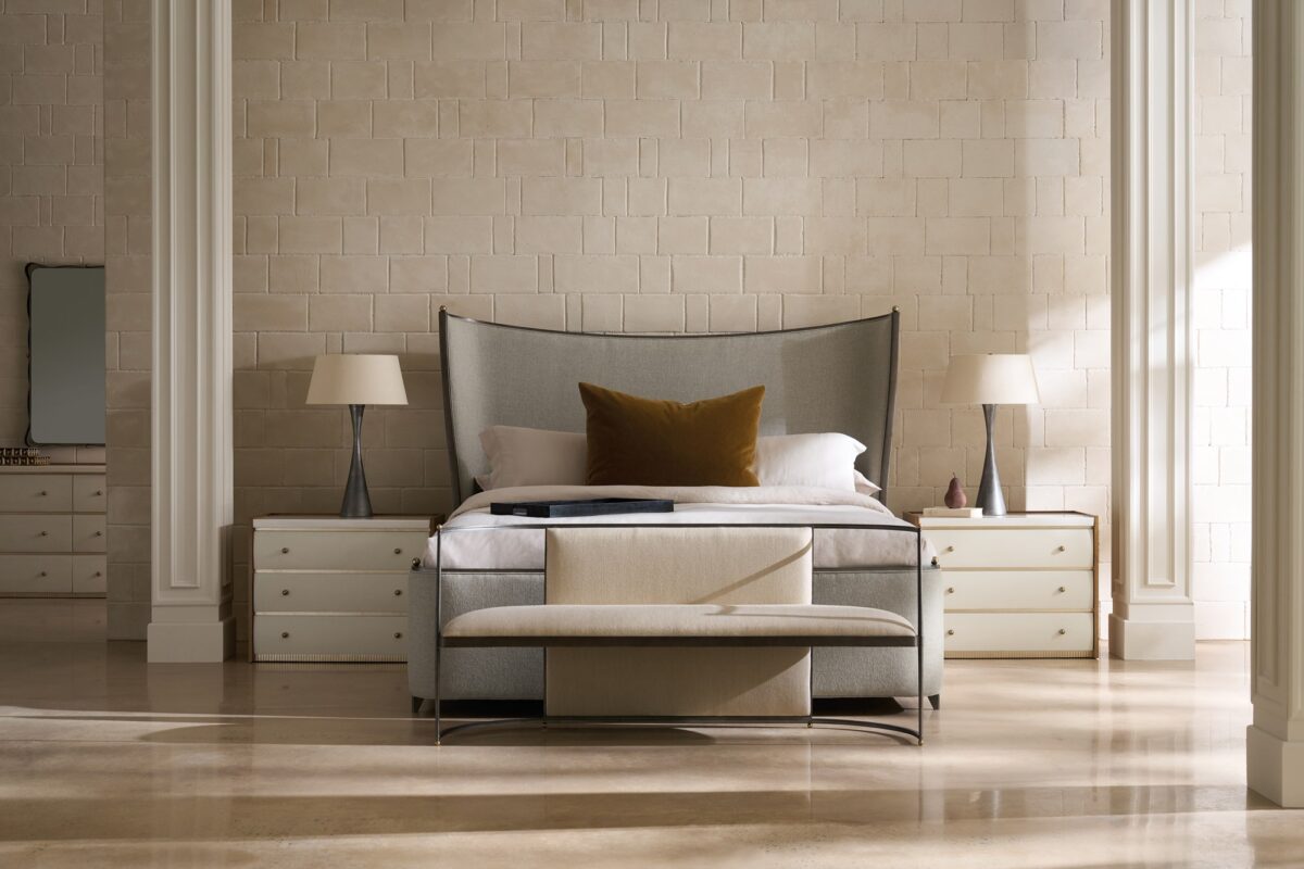 Caracole Avignon Nightstand — a 34″‑wide three‑drawer nightstand with tactile Rockport Burnished Adobe drawer fronts, topped with a striated white Guangxi/onyx stone surface, flanked by Toasted Sycamore end panels, adorned with antique‑bronze‑leaf dentil molding at the base, and brushed‑gold ball knobs on soft‑close undermount guides.