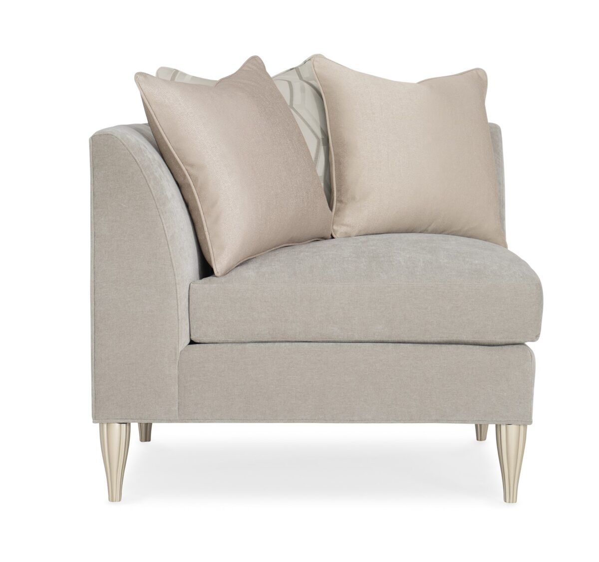 Caracole Fret Knot Corner featuring a carved fret panel inspired by a narrow castle window, Soft Silver Paint finish, fluted conical legs, and a supportive eight-way hand-tied seat.