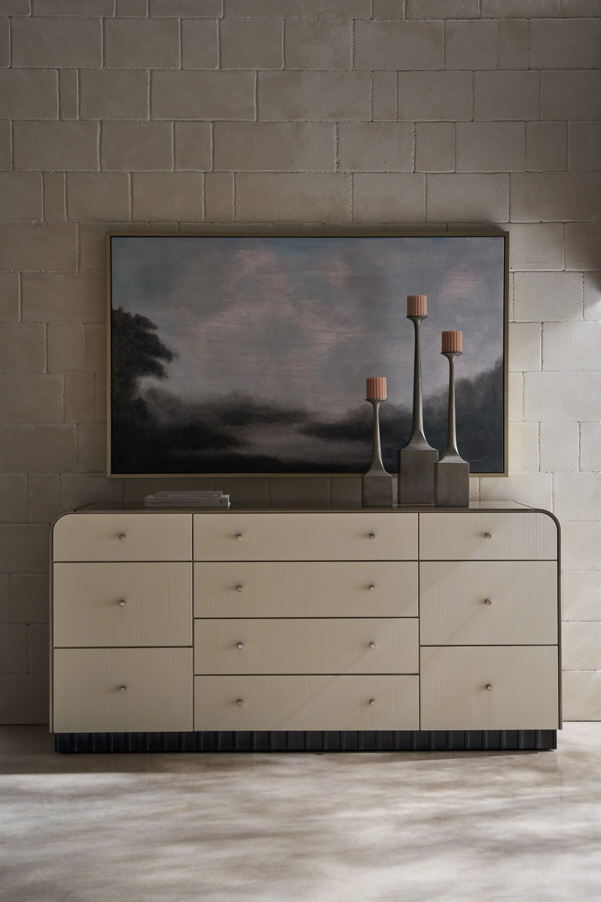 Caracole Circadian Dresser – Neoclassical-inspired 10-drawer dresser featuring micro-fluted ivory drawer fronts, a waterfall top in Whisper of Gold paint, and a contrasting Dark Chocolate scalloped base.