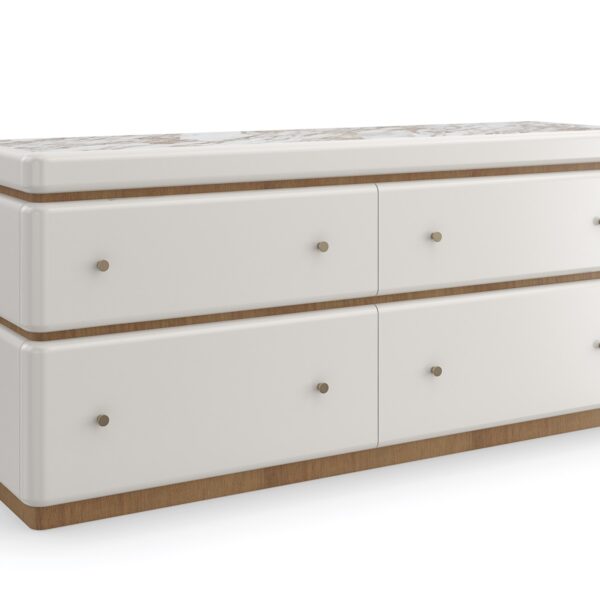 Milos Dresser by Caracole — a 65″‑wide modern dresser in Almond Milk finish with gently rounded stacked silhouette, featuring four soft‑close drawers trimmed in Toasted Pecan, topped with Calacatta Oro marble, and equipped with a removable felt‑lined tray in the top drawer.