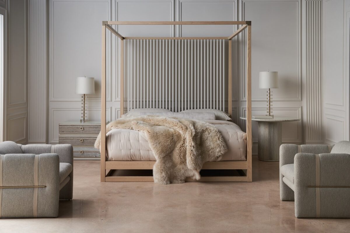 Bedrock Nightstand by Caracole — a 34″‑wide three‑drawer nightstand with polished gray sandstone fronts featuring subtle champagne‑gold trim and ring pulls, set in a creamy Almond Milk wood frame with a matching plinth base and soft‑close undermount drawer guides.