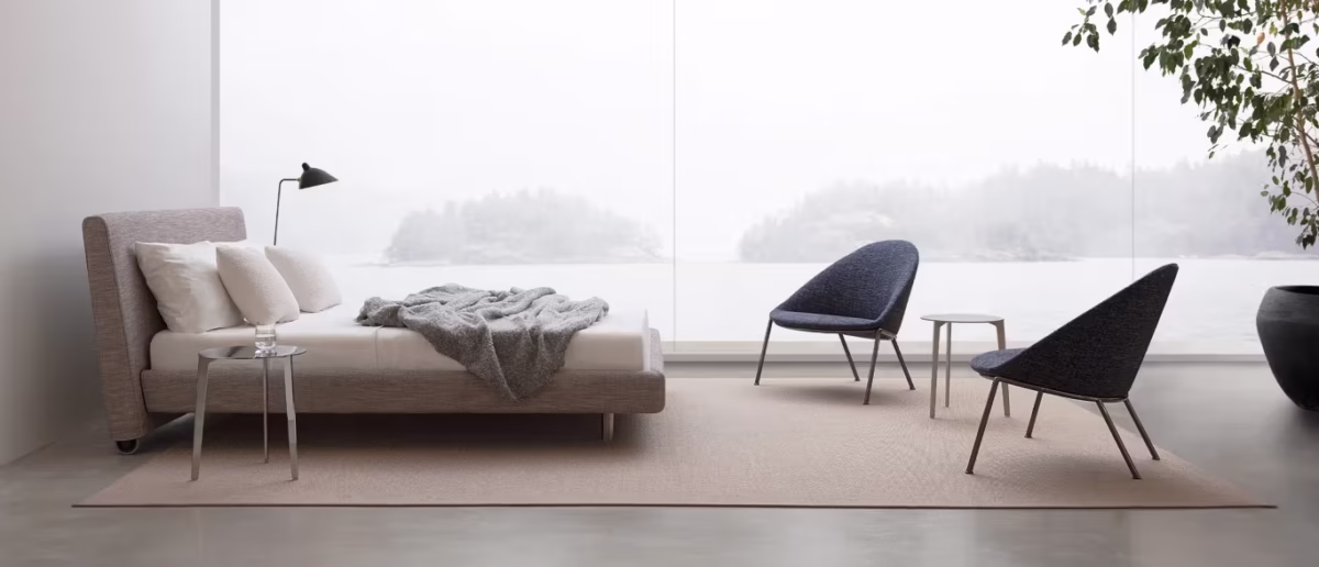 Onto by Bensen lounge chair in soft beige fabric with low back and wide seat in a modern living room setting