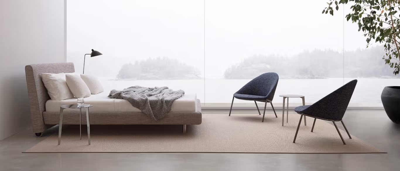Onto by Bensen lounge chair in soft beige fabric with low back and wide seat in a modern living room setting
