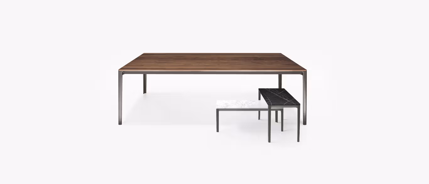 Able Table by Bensen with a slim walnut top and minimalist black metal legs in a modern dining room