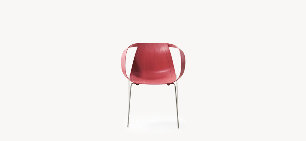 Red Impossible Wood armchair by Moroso, with molded shell showcasing vertical grain-like lines and slender steel legs