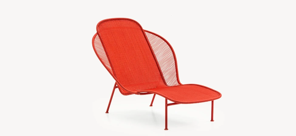 Imba chaise longue in bright yellow, with a sweeping curved seat and back made from handwoven polyethylene threads