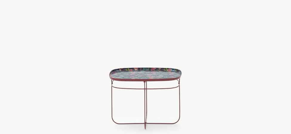 Ukiyo Table by Moroso with bright red tubular steel base and floral kimono‑fabric resin round top, front view in a Royal Oak Michigan showroom