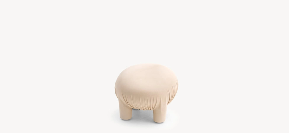 Anomaly Pouf by Moroso in undyed vegetal-tanned leather resembling a friendly creature, front view in a Royal Oak Michigan showroom