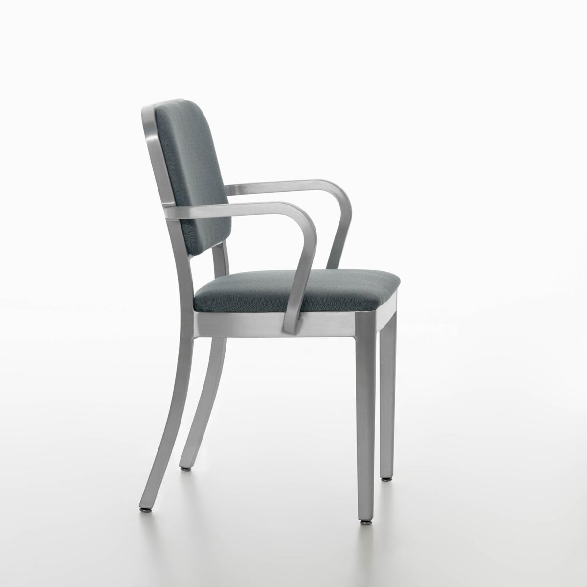 “Emeco Navy Officer Armchair with a classic military-inspired design and comfortable padded seat.”