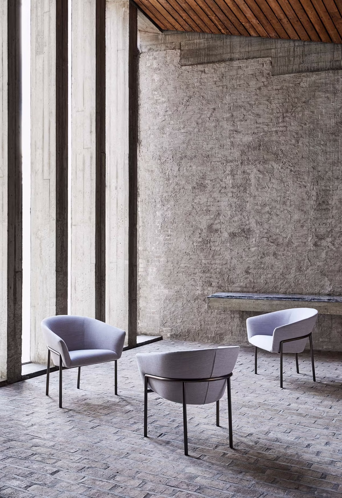 Modern interior featuring Metro by Bensen chair in charcoal upholstery next to a wooden side table