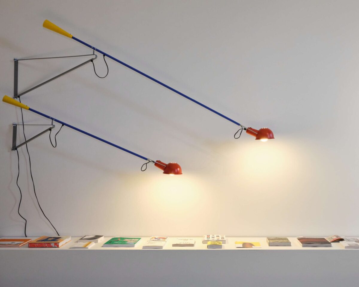A minimalist Flos 265 Small lamp, with its elongated, movable arm and circular shade, designed for flexible lighting over a dining table, desk, or lounge area.