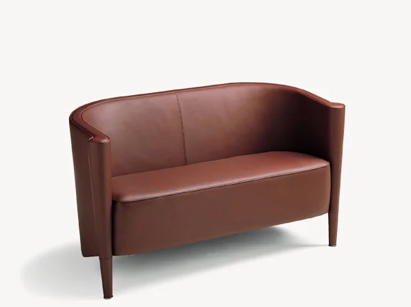 Side view of the Rich sofa by Moroso, showcasing its elegant curved backrest and wooden legs in a neutral finish.