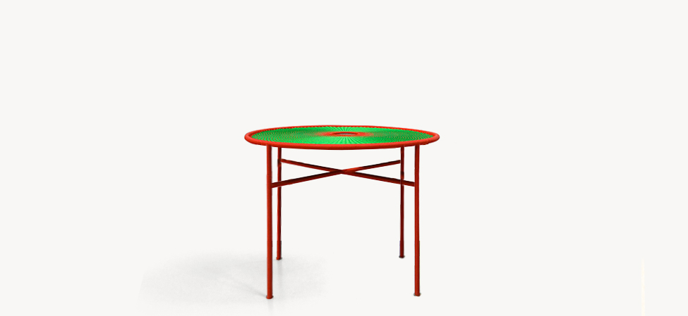 Banjooli by Moroso chair with multicolored patchwork upholstery and curved wooden legs in a bright living room