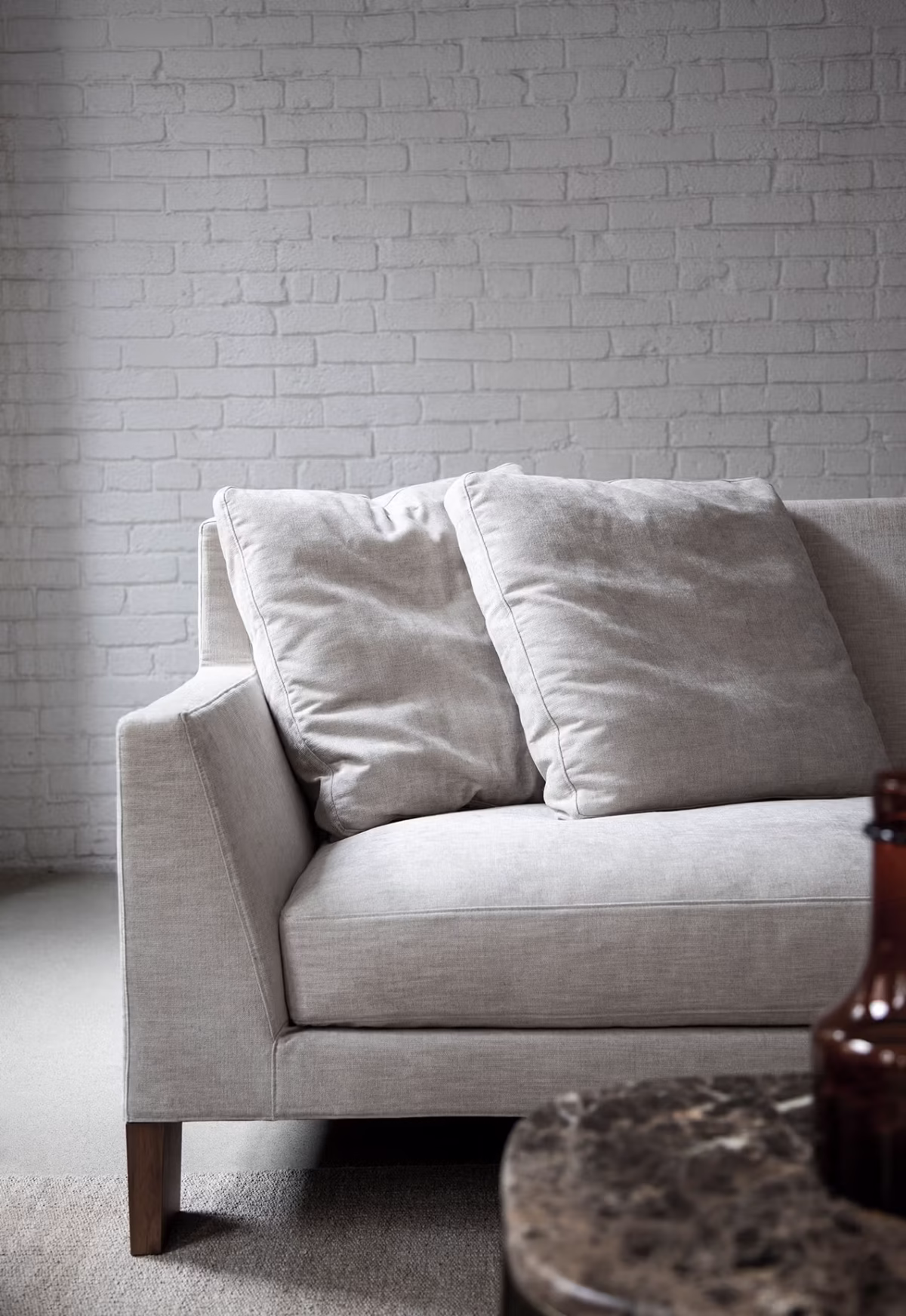 Contemporary interior featuring Morgan by Bensen chair in gray upholstery paired with a minimalist wooden side table