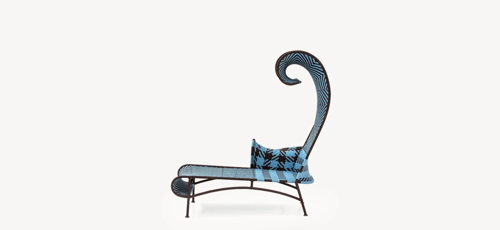 Shadowy chaise longue by Moroso in soft gray upholstery with a sleek curved silhouette and black metal legs