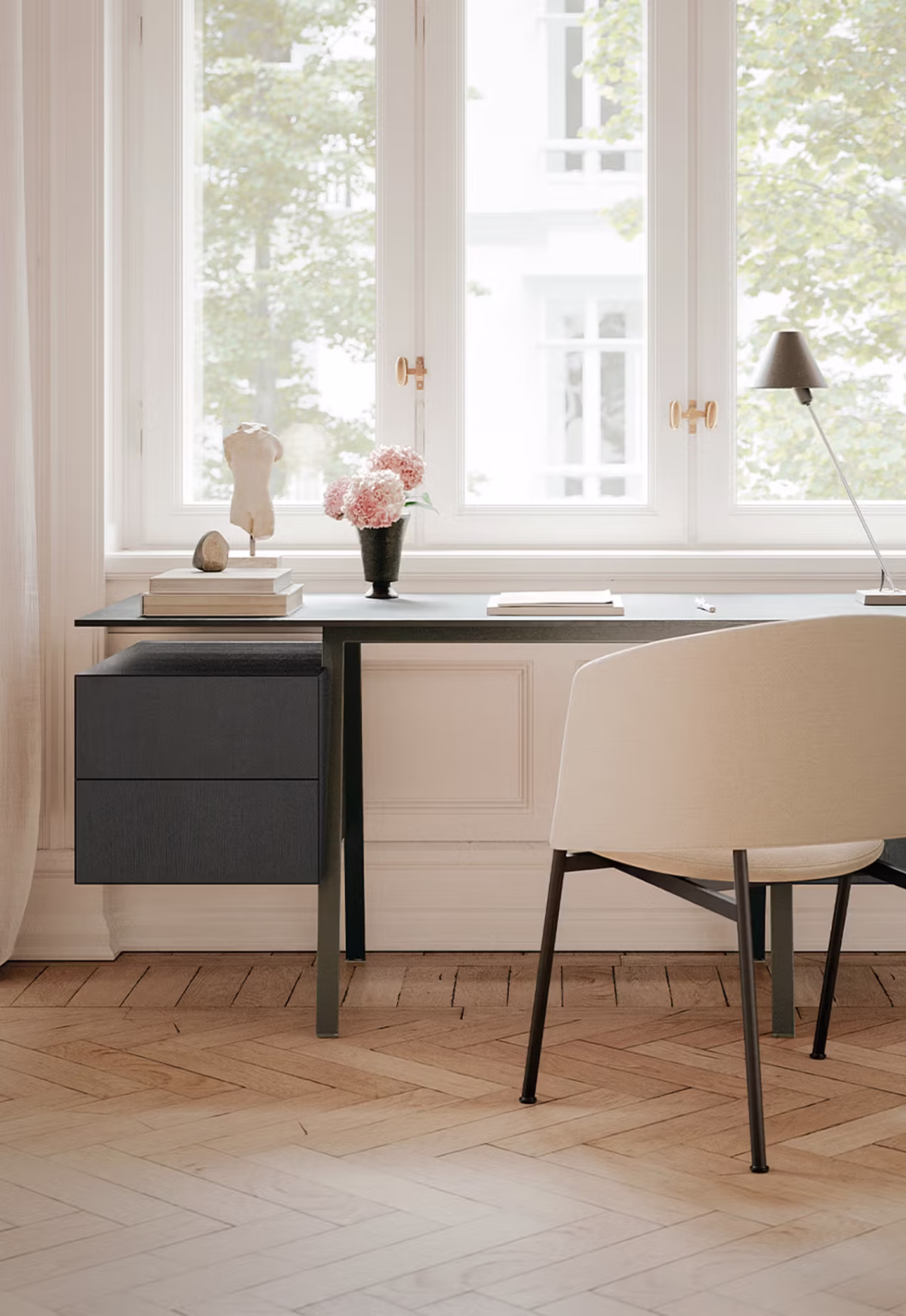 Homework Wood Top desk by Bensen in light oak finish positioned near a large window with natural light
