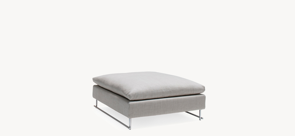 Shanghai Tip pouf by Moroso in soft grey fabric with clean lines and chrome tubular legs, placed in a minimalist living room setting