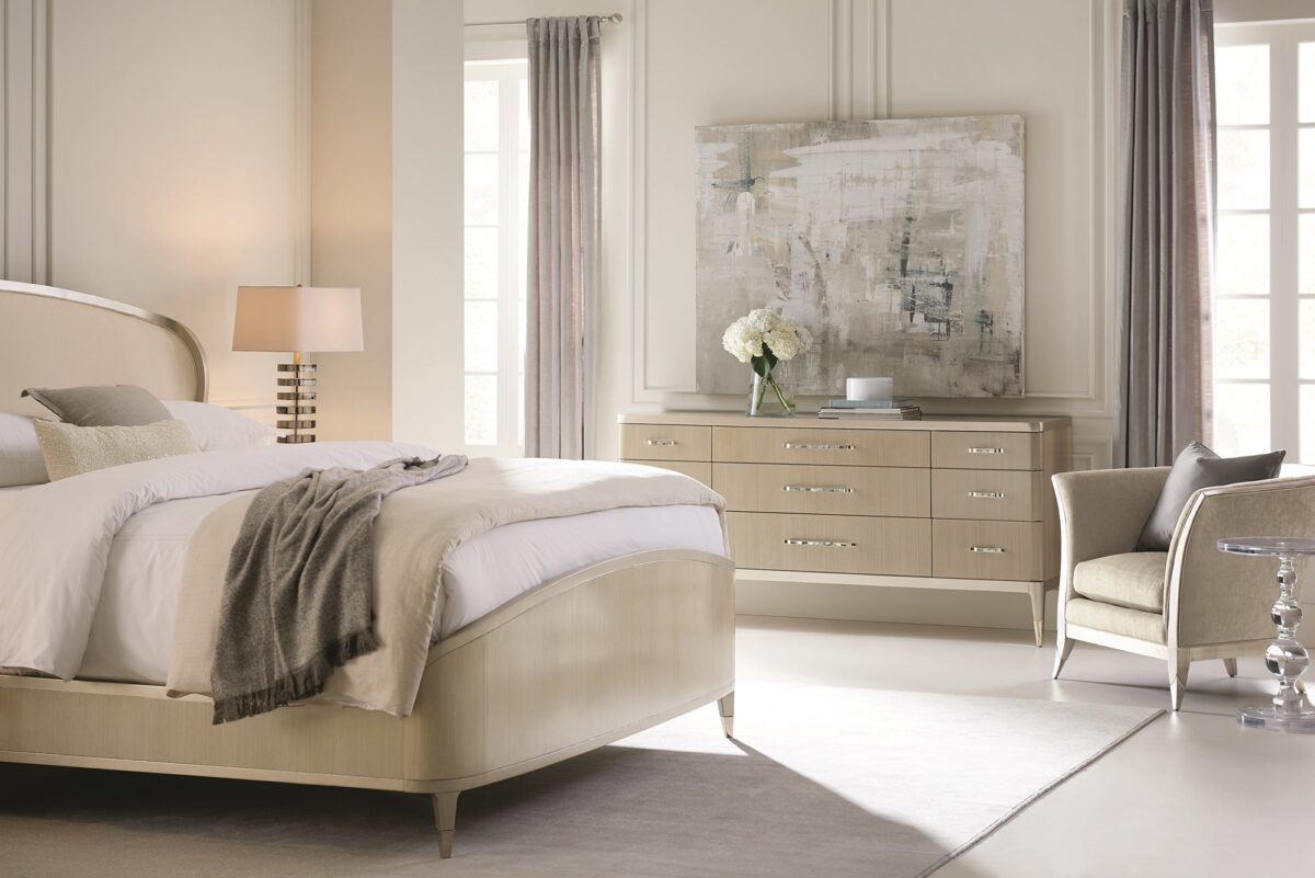 Caracole ALL DRESSED UP chest, featuring a unique cracked glass or shattered mirror effect on its door panels, contrasted with a smooth wood finish.