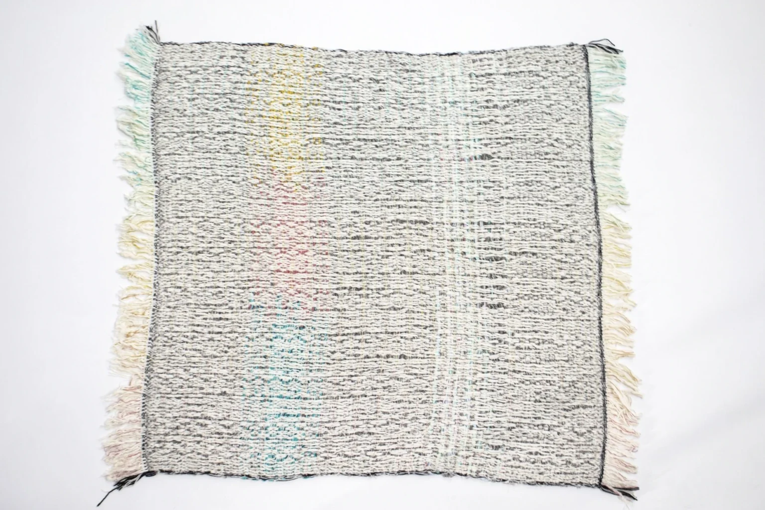 7Plaids Throw by Moroso showcasing artisanal patchwork and floating thread details at the Michigan Design Center