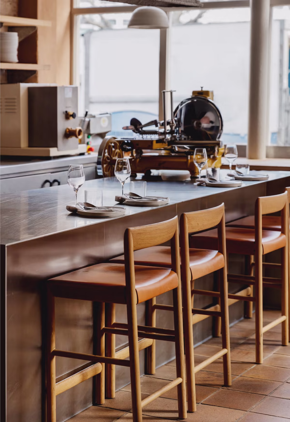 Stax Stool by Bensen arranged at kitchen island