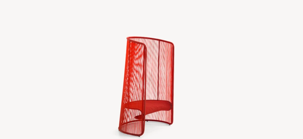 Detail shot of Husk stool's handwoven polyethylene threads in green, emphasizing craftsmanship and texture